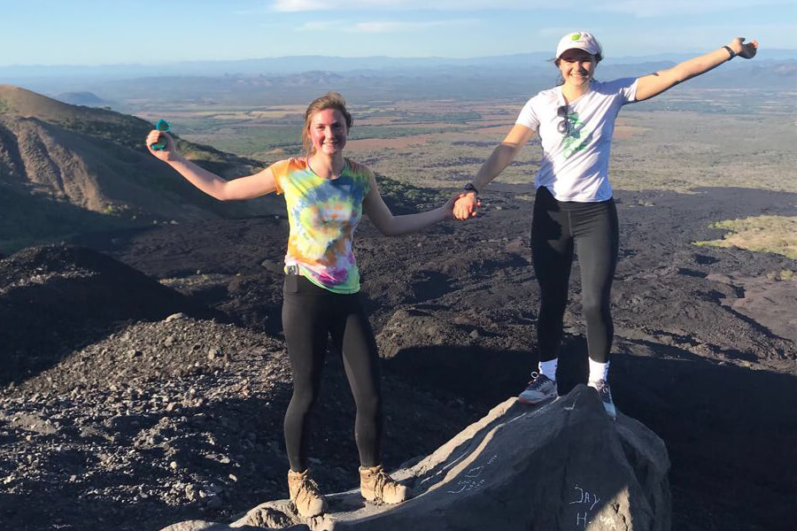 Anna Collins and Callista Ohnemus stand on a cliff's edge in Nicaragua.