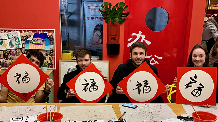 Students with Red Chinese Caligraphy