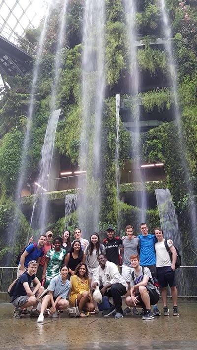 Group of students in front of a waterfall in Singapore