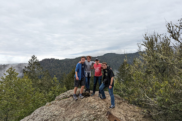 Group of students on a rock outside