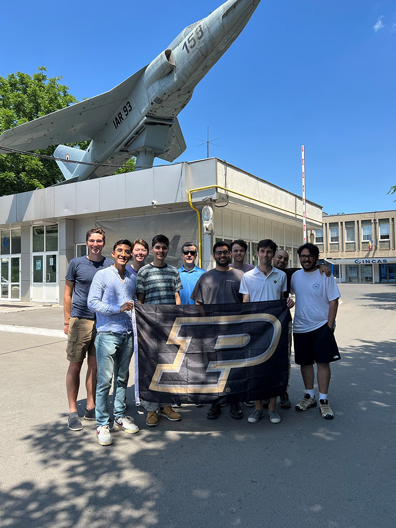 A group of students standing in front of a castle.