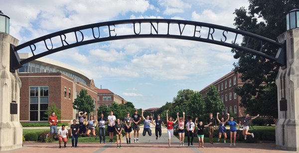Students Jumping in front of the arch