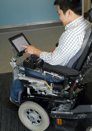 Person in wheelchair using a Robotic Desk component
