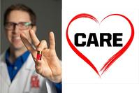 Aaron Becker (unfocused in background), holds a tube of red fluid with a chip inside of it in the foreground and in focus.