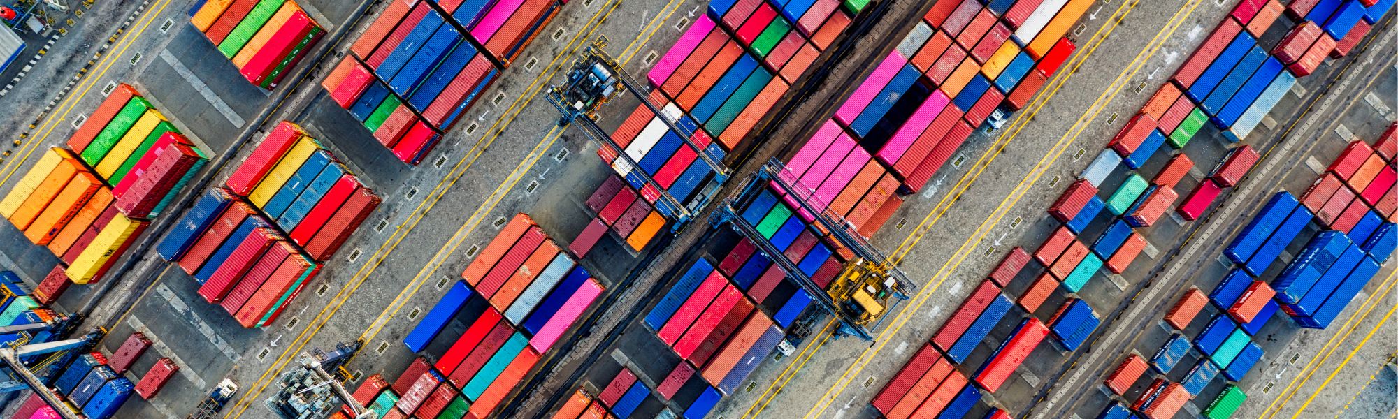 rows of cargo containers, representing a piece of the supply chain