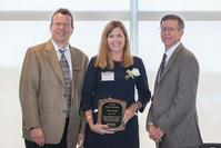 Photo of Amy Adams receiving Co-op Hall of Fame plaque