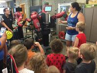 Photo of Maru Cabrera, robot and students