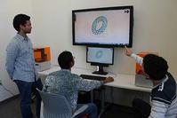 Photo of Prof. Martinez (r) explaining 3D printer use