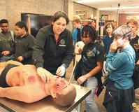 Photo of Cabrera, students and mannequin