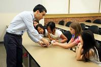 Photo of Ramses Martinez teaching elementary students