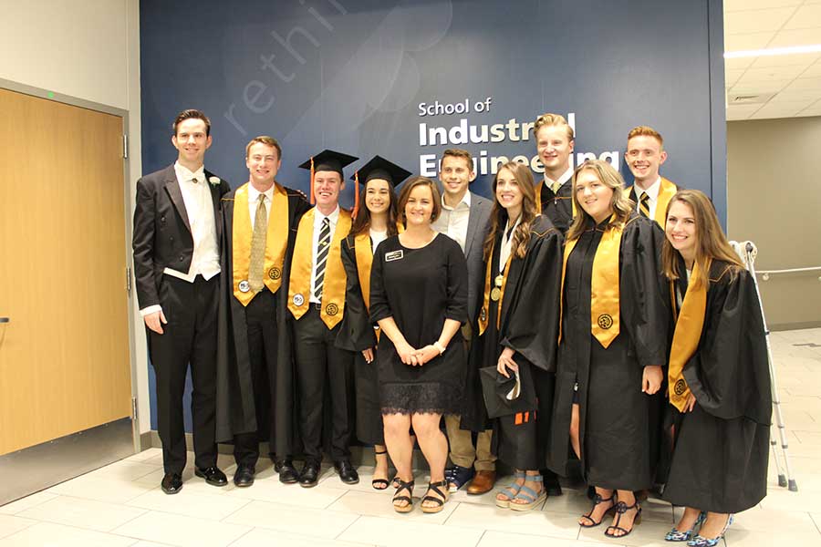 Sr. Undergrad Advisor Elizabeth Allum (center) with new graduates