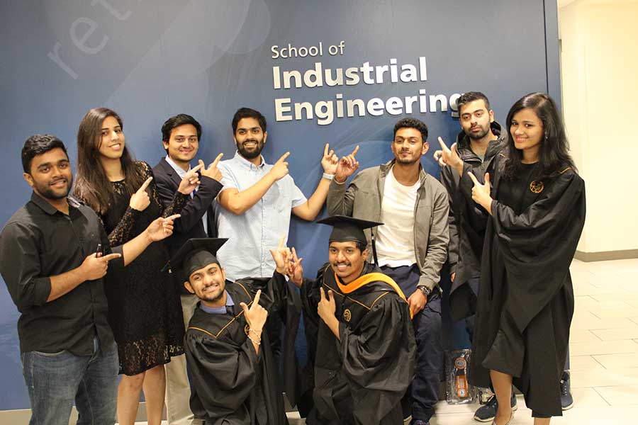 Photo of group of IE grads thumbs-up