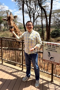 Photo of Professor Wu with a Giraffe