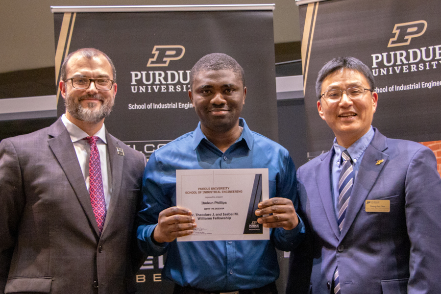 Ibukun Phillips accepting an award with Dr. Pat Brunese (Left) and Dr. Young-Jun Son (right)