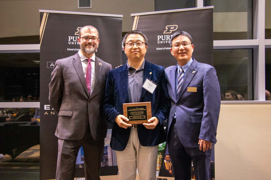 Photo of Wenzhuo Wu receiving Pritsker Best Teacher Award