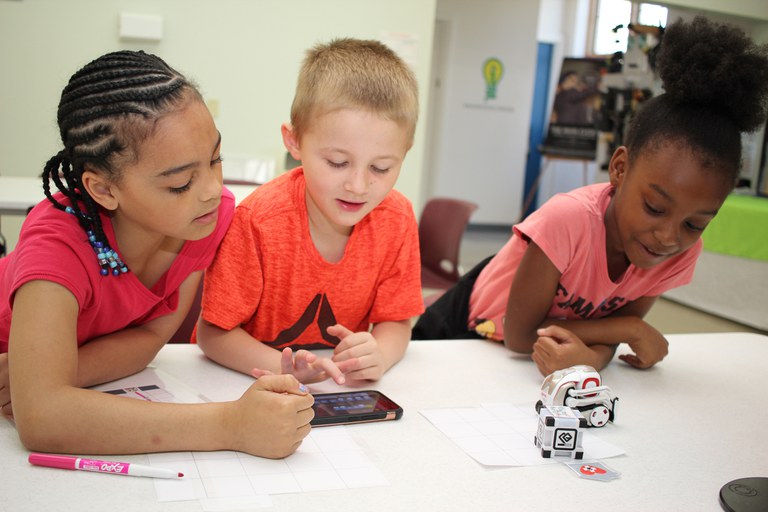 Children playing with Cozmo the Robot