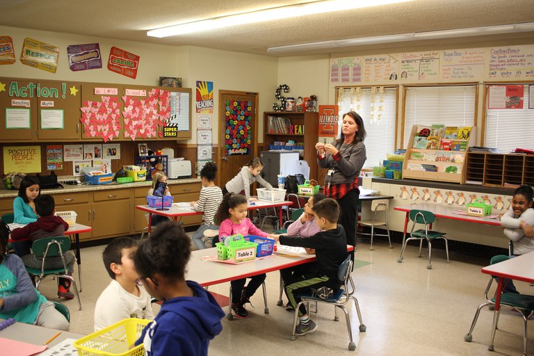 Classroom of children listening to a teacher