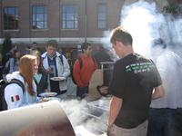Smoke curls around students as they grill