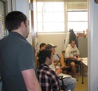 Students listening to Prof. Allain in his office.