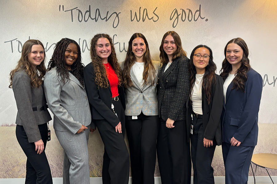 Group of students standing in front of a wall with "today was good" written on it.