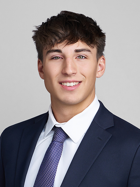 Student with short dark hair, blue eyes, smiling