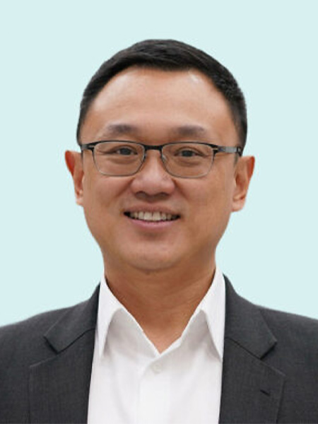 Man in a suit with black glasses on a robin's egg blue background
