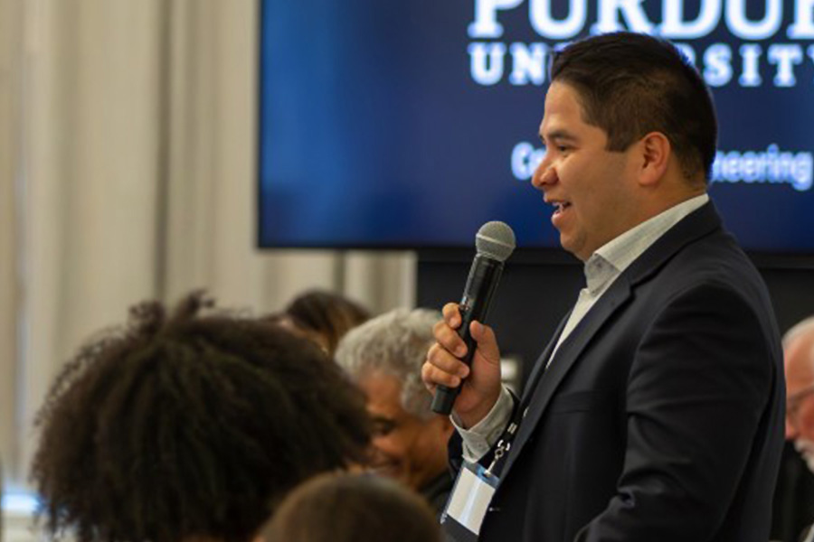 Portrait of a man holding a microphone within a crowd