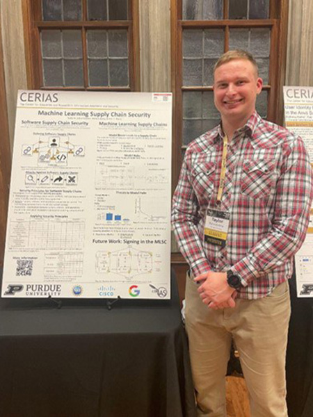 Lt Taylor Schorlemmer with CERIAS poster