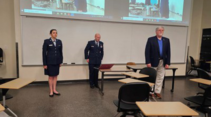 Lt Caitlin Pessolano with Major Glenn Peterson and Dr. Walter Jones, Director and Chancellor, Air Force Institute of Technology during PMRI seminar class