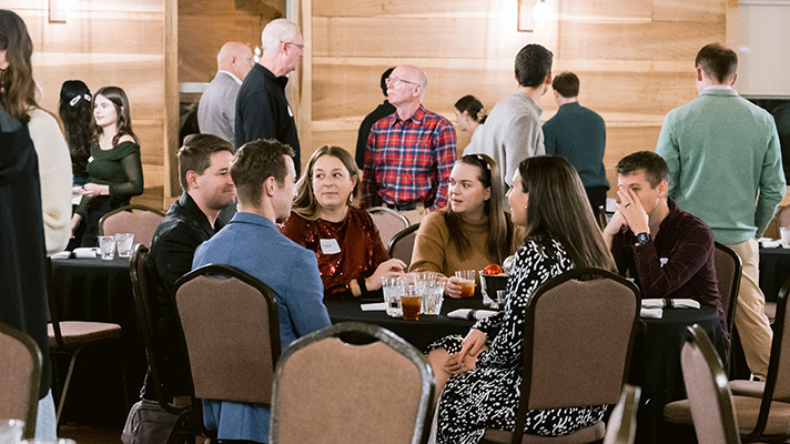 Students seated together at a table during the PMRI December gathering