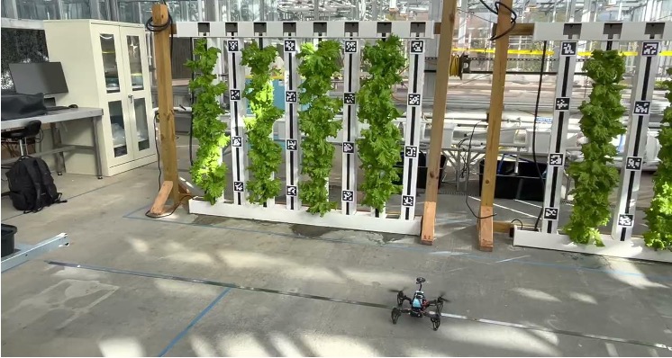 A drone hovering in front of a vertical farming structure
