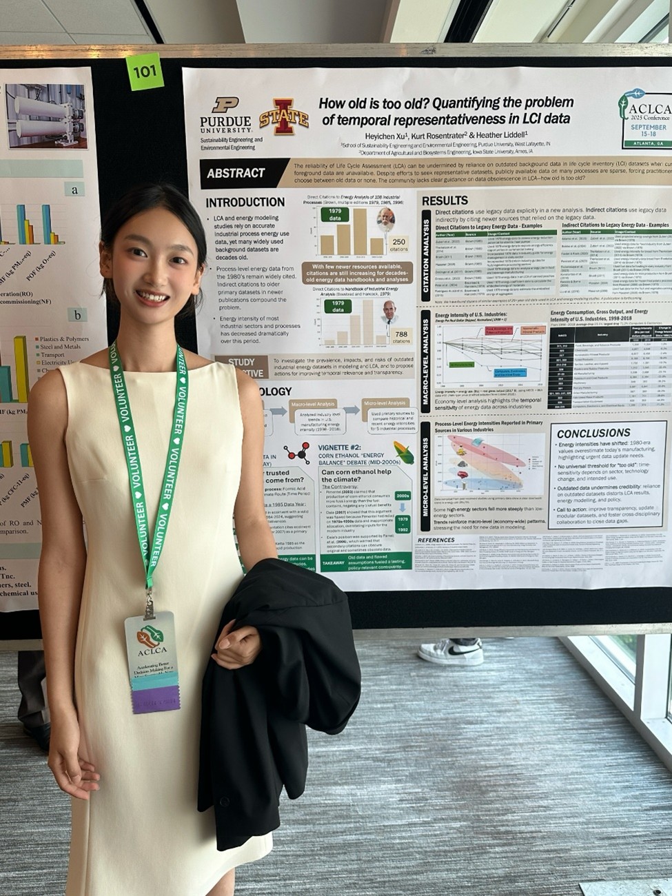 Heyichen Xu standing in front of poster.