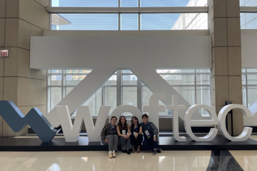 Purdue team in front of the WEFTEC sign