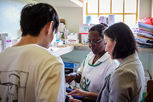 Photo of Dawei Wang & Yuehwern Yih w/nurse in Uganda