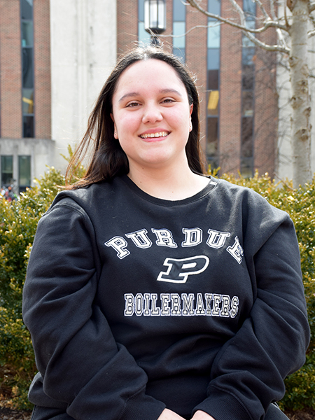 Matiana De Alba smiling, wearing a black sweatshirt with "Purdue" 