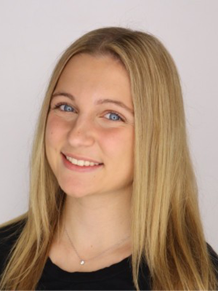 Student with blonde hair and blue eyes, smiling, in a head shot