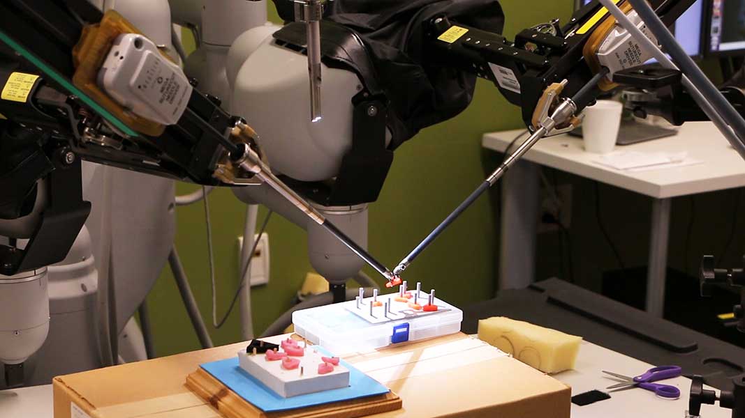 Photo of daVinci arms manipulating triangles