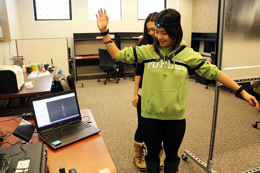 Photo of 2 students manipulating wearables software