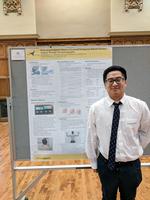 Photo of Guoyang Zhou with poster