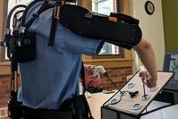 Photo of surgical team member using exoskeleton equipment.