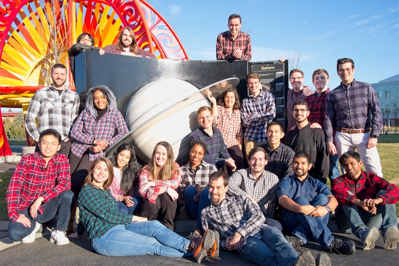 The research group around a Saturn sculpture. Back row (left to right): Kenji Kitamura, Brian McCarthy, and Nick LaFarge. Middle row: Andrew Molnar, Bonnie Prado Pino, Robert Pritchett, Kenza Boudad, Stephen Scheuerle, Collin York, Rolfe Power, and David Canales Garcia. Front row (squatting, sitting, kneeling): Beom Park, Emily Spreen, Maaninee Gupta, Paige Whittington, Nadia Numa, Andrew Cox, Ricardo Gomez, Juan Ojeda Romero, Fouad Khoury, Vivek Muralidharan, and Rohith Sanaga.