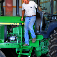 Farmer exits his tractor via custom mounted steps